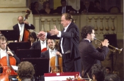 Riz Ortolani direct the Symphony Orchestra of the Municipal Theater of Bologna in a scene from the Pupi Avati movie “Ma Quando Arrivano le Ragazze?”, on the trumpet, the actor Claudio Santamaria
